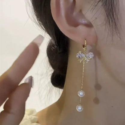 Super flash crystal bow fringed earrings, high-end long pearl earrings, versatile temperament, showing face and thin earrings for women